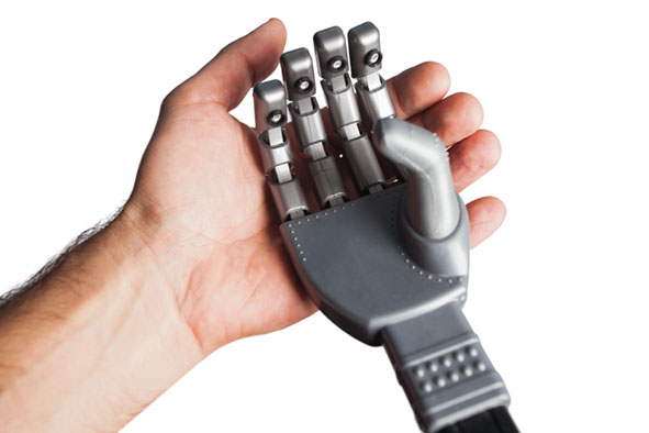 isolated human hand holding robotic hand