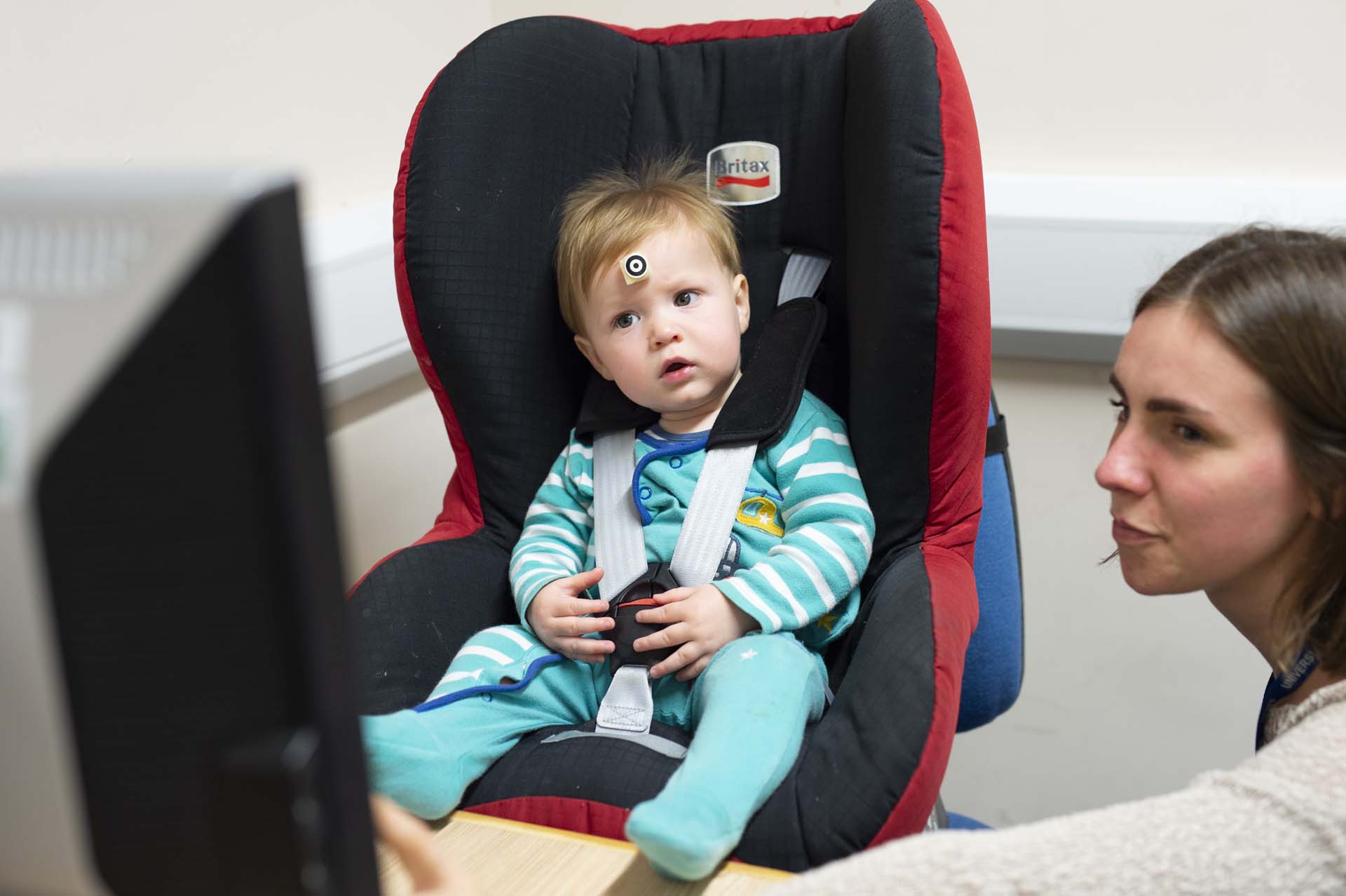 Small child taking part in research using eye-tracking equipment
